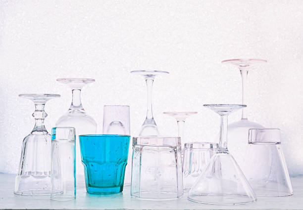 istock Glass goblets of different shapes and a multi-colored on a white 646247342