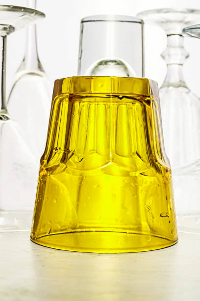 istock Glass goblets of different shapes and a multi-colored on a white 646247350