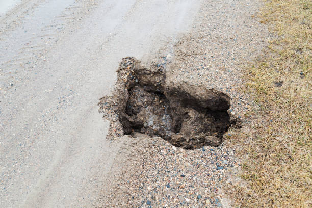 istock Sinkhole on Gravel Road in Springtime 646251566
