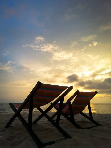 istock Sunrise over sea, silhouette two canvas beach bed 646252436