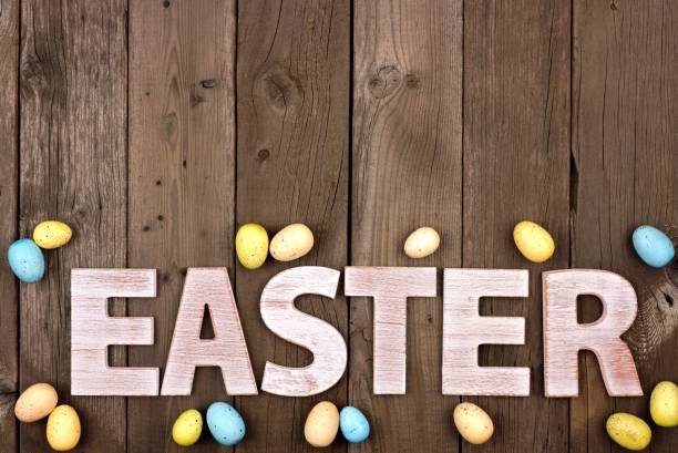 easter white wooden letters with easter eggs over rustic wood - easter text single word paint imagens e fotografias de stock