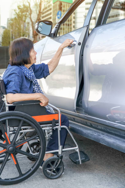 istock Elderly woman open door car 646287276