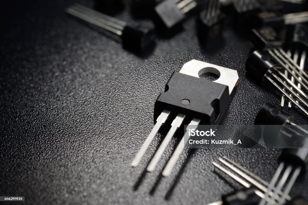 Black power transistors Macro shot of power transistors on the black surface Transistor Stock Photo