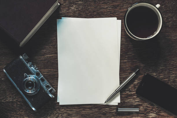 istock Sheets of paper, retro camera and smartphone on table. Writing a story. 646298296