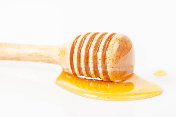 istock Honey dripping with honey stick. 646302702