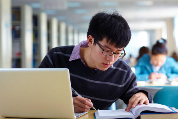 istock One young asian male college student study in the library 646303568