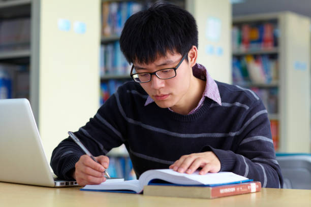 istock One young asian male college student study in the library 646303576