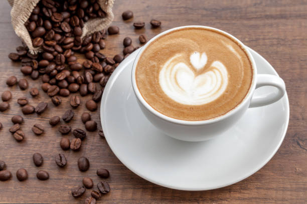 istock Coffee cup of latte art with coffee beans 646309164