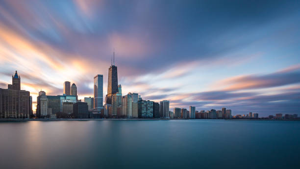 Chicago by the Lake Long exposure of the Chicago skyline during sunset. chicago illinois stock pictures, royalty-free photos & images