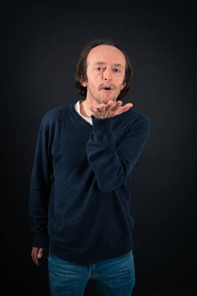 istock Handsome man doing different expressions in different sets of clothes: kiss 646321716