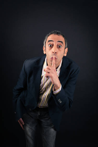 istock Handsome man doing different expressions in different sets of clothes: be quiet 646325890