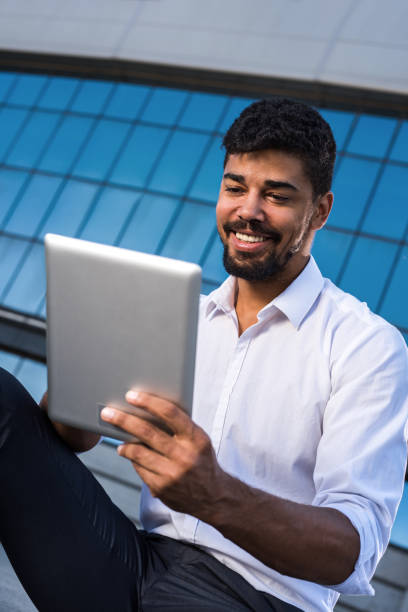 istock Happy African American businessman reading data from a touchpad. 646337784