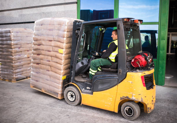 istock Male forklift driver working with palettes outdoors. 646338060