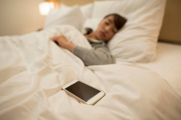 istock Sleeping woman and smartphone 646338924