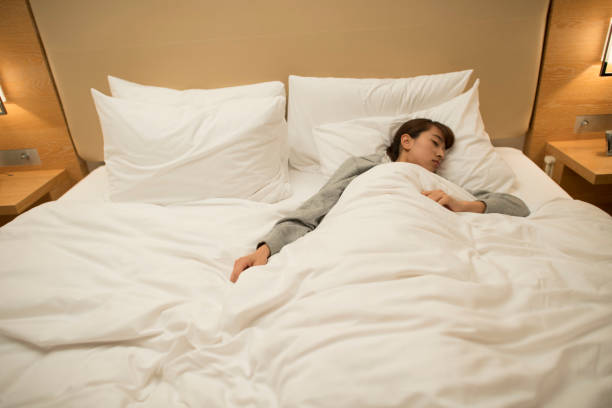 istock Japanese woman sleeping on a bed 646338956