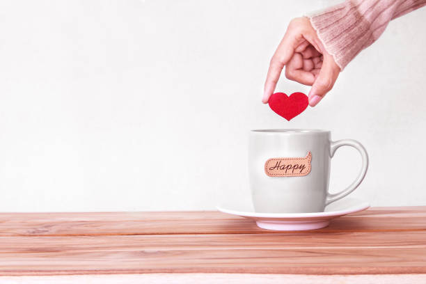 istock hand holding  red heart shape put into a Coffee cup 646340720