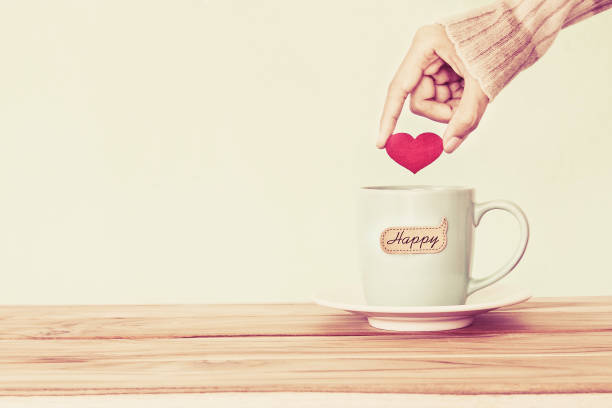 istock hand holding  red heart shape put into a Coffee cup 646341792