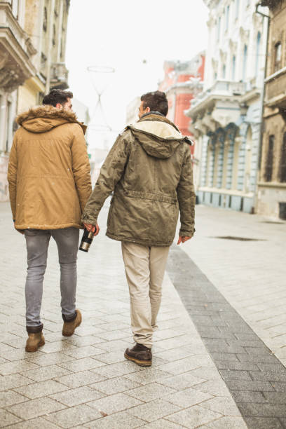 istock Two young man walking down the street 646353564