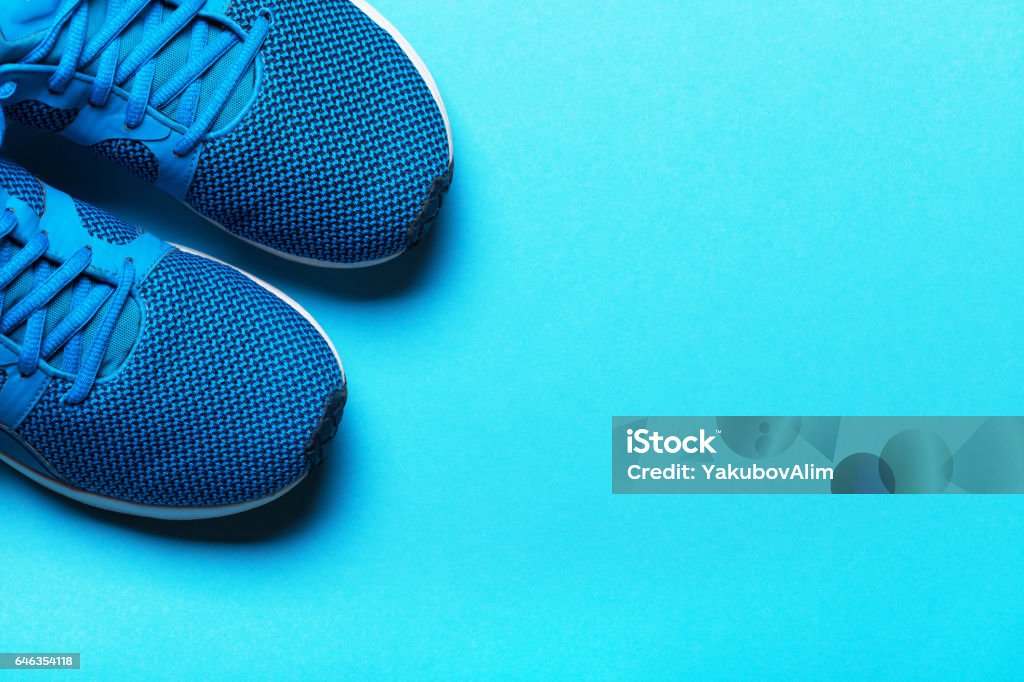 One Pair of blue sport shoes on blue background. Sports Shoe Stock Photo