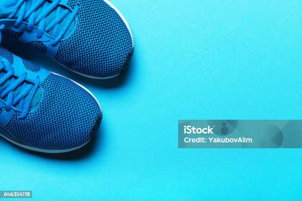 One Pair Of Blue Sport Shoes On Blue Background Stock Photo - Download Image Now - Sports Shoe, Men, Active Lifestyle