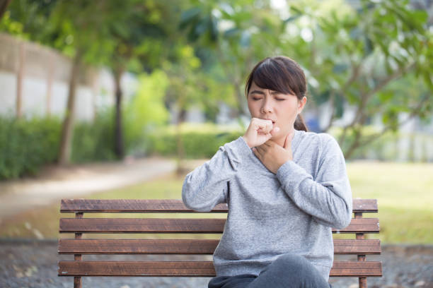 istock Woman has sore throat at park 646362916
