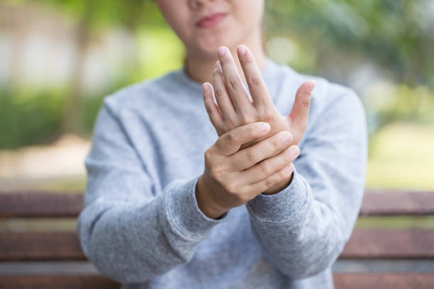 istock Woman has hand pain at park 646371000