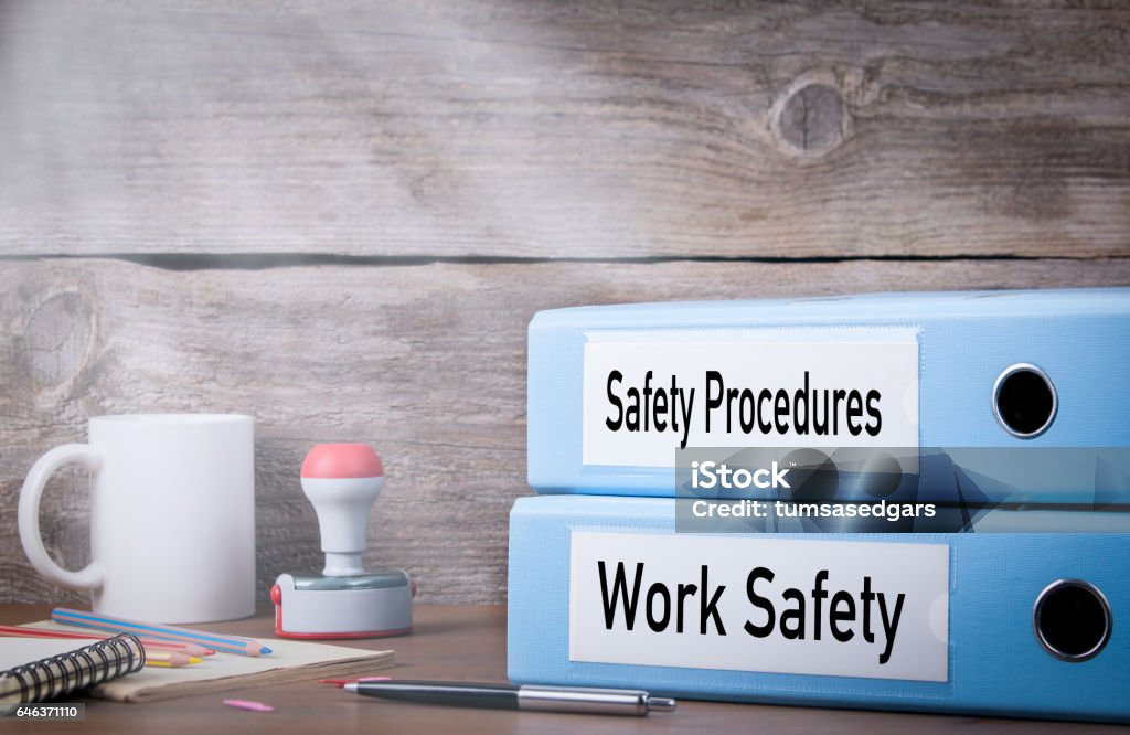 Work Safety and Safety Procedures. Two binders on desk in the office. Business background Work Safety and Safety Procedures. Two binders on desk in the office. Business background. Safety Stock Photo