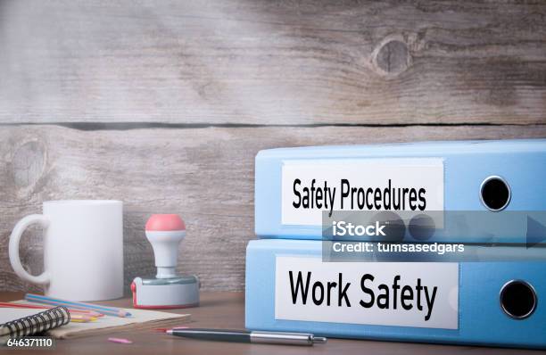 Work Safety And Safety Procedures Two Binders On Desk In The Office Business Background Stock Photo - Download Image Now