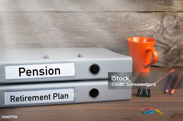 Retirement Plan And Pension Two Folders On Wooden Office Desk Stock Photo - Download Image Now