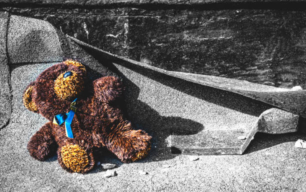 istock teddy bear on a background of gray brick wall 646378510