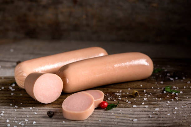 Raw frankfurter sausages with spices stock photo