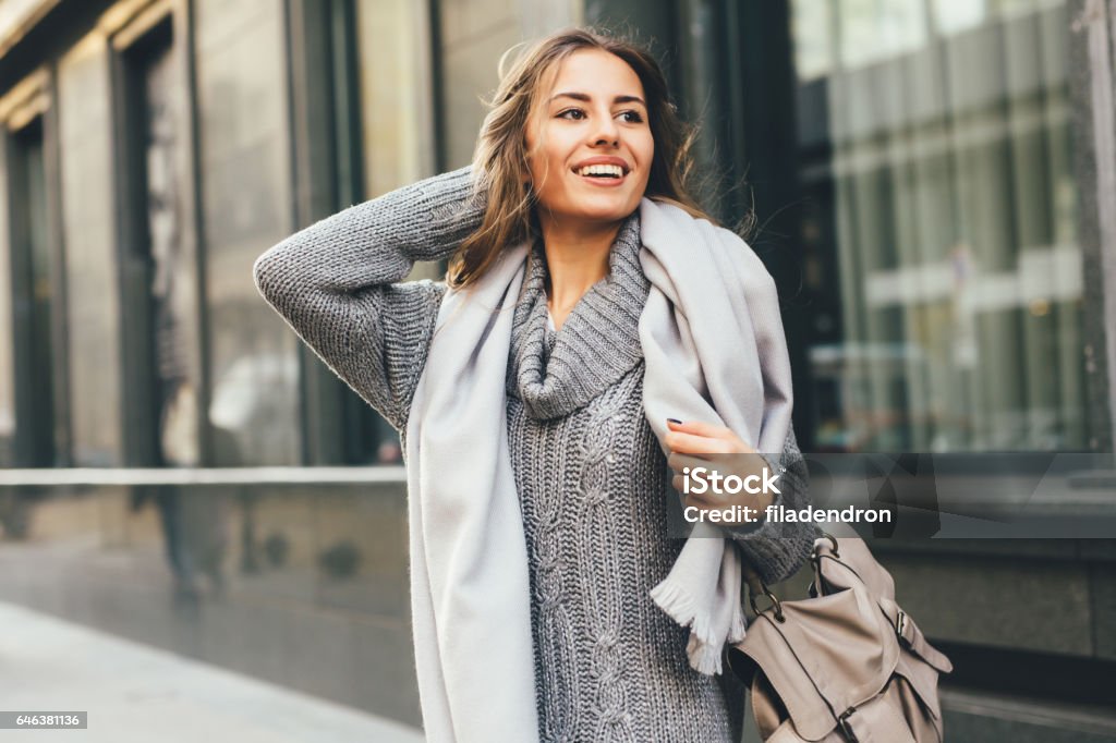 Beautiful woman in the city Portrait of a beautiful young woman outdoors. Sweater Stock Photo