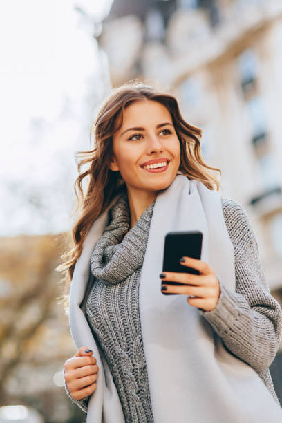 istock Young woman texting outdoors 646381144