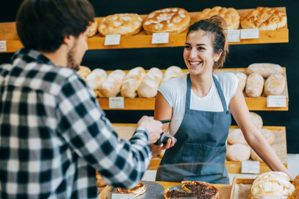 istock Young man making a contactless payment at a bakery 646381264