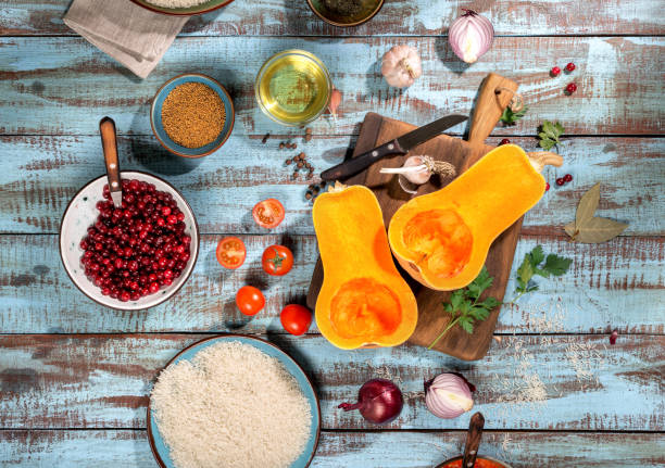 istock Ingredients for preparation baked squash on blue wooden table 646390264