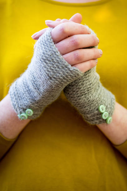 istock Hands Wearing Knitted Fingerless Gloves 646392650