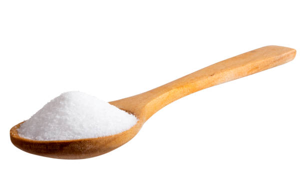 istock Salt in wooden spoon isolated on white 646399704