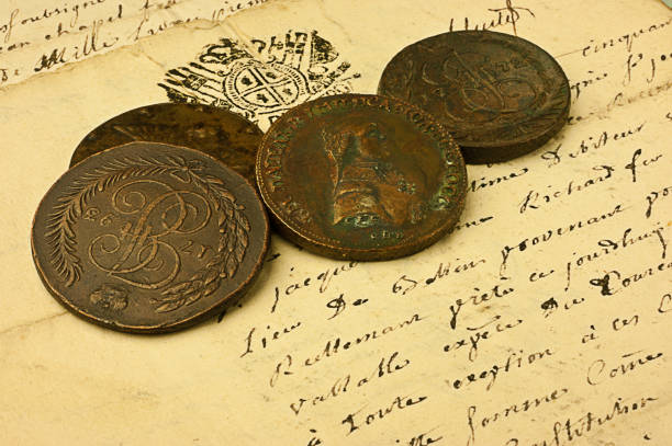 istock Ancient Coins over an old manuscript 646409888