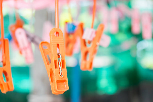 Clothespins attached to a utility rope against a blurred background, offering ample copy space.