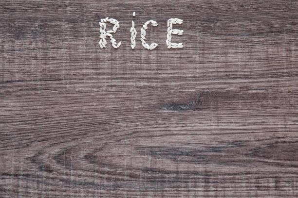 istock Word rice created from rice on the wooden background. 646414194