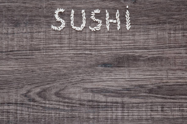 istock Word sushi created from rice on the wooden background. 646415896