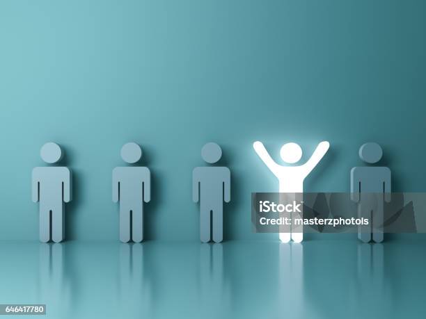 Stand Out From The Crowd And Different Creative Idea Concepts One Glowing Light Man Standing With Arms Wide Open Among Other People On Green Background Stock Photo - Download Image Now