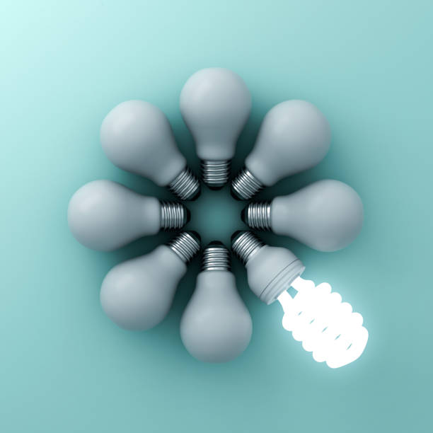 istock Eco energy saving light bulb , one glowing fluorescent lightbulb standing out from unlit incandescent bulbs on green background individuality and different creative ideas concepts 646417786