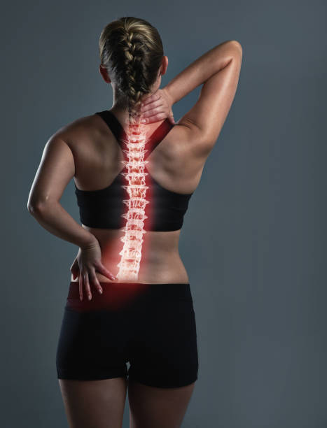 There’s nothing a deep tissue massage can’t fix Rearview shot of a sporty young woman holding her back in pain backache photos stock pictures, royalty-free photos & images