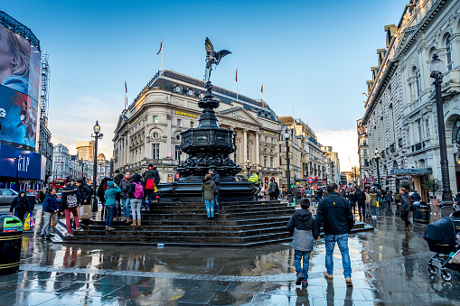 London, UK - February 2, 2017: Crowds of people and tourists visiting piccadilly circus on after a stormy afternoon