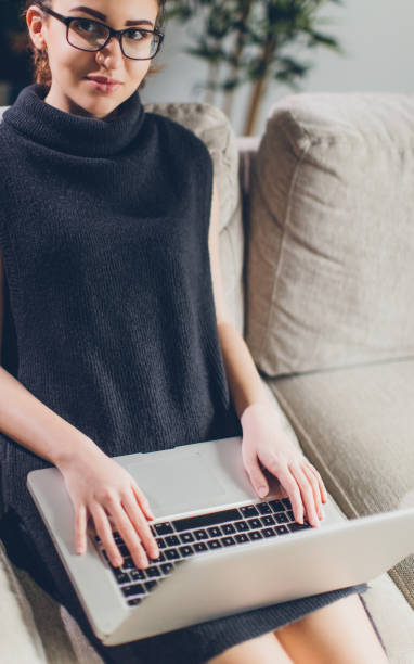 istock Happy woman using laptop at home 646425854