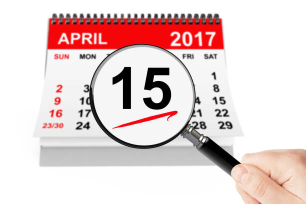 istock Tax Day Concept. 15 april 2017 calendar with magnifier 646427064