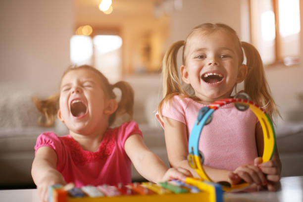 istock Two little girl at music school. 646436736