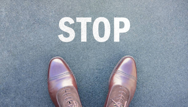 istock Stop message and top view of perfect kept business shoes 646436896