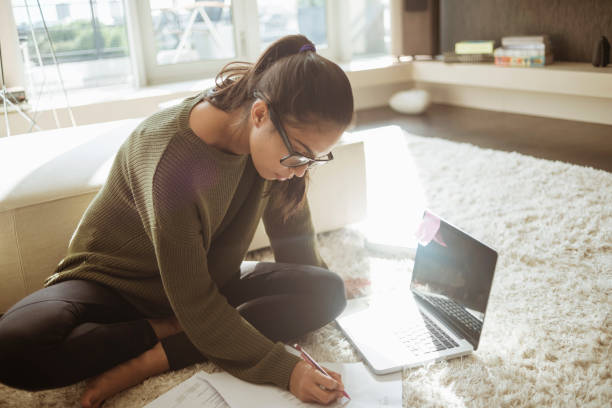 istock young woman studying in her living room 646439620